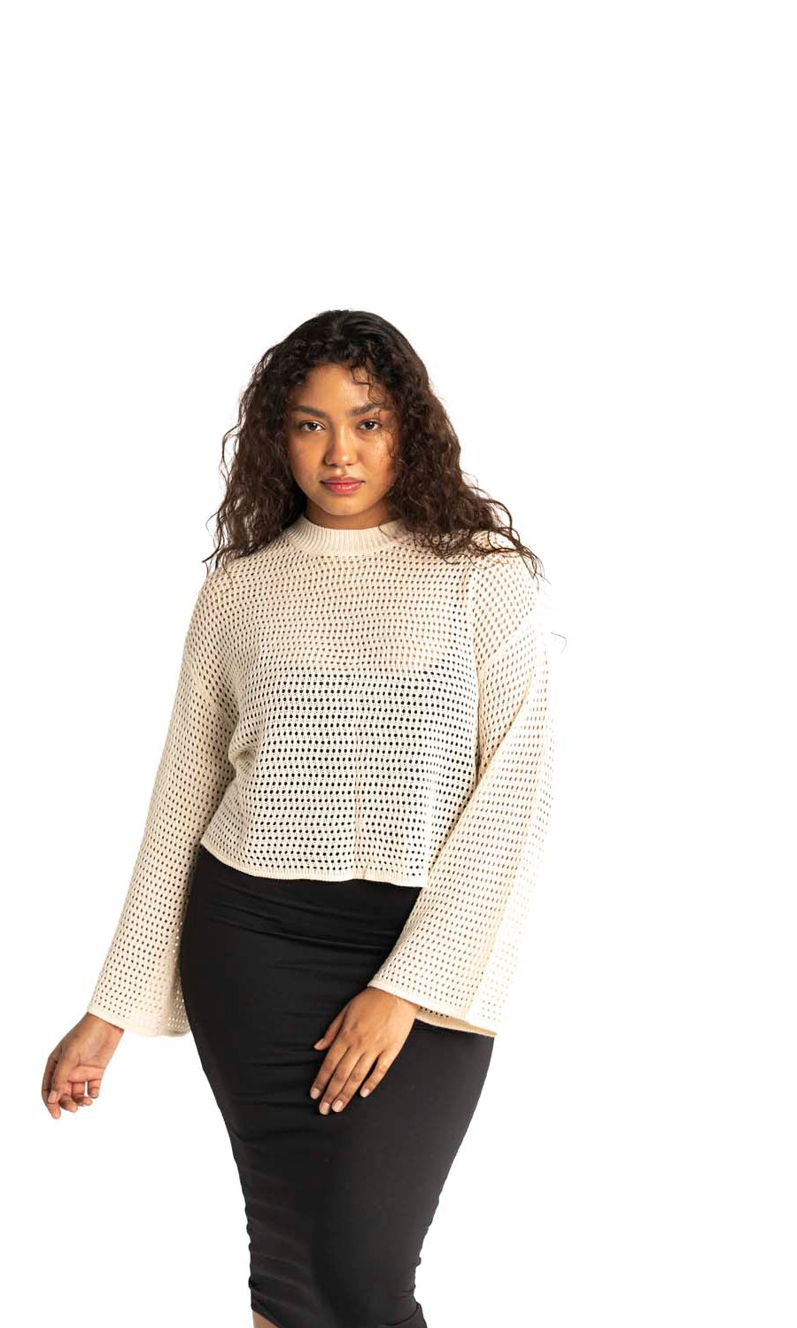 white crochet style open knit sweater worn by woman gyal bashy
