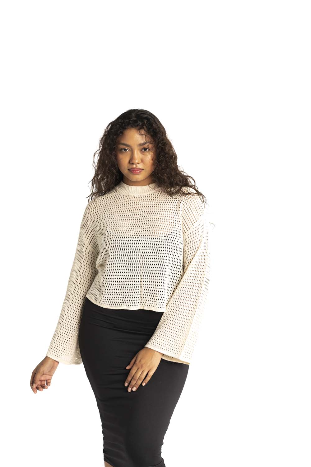 white crochet style open knit sweater worn by woman gyal bashy