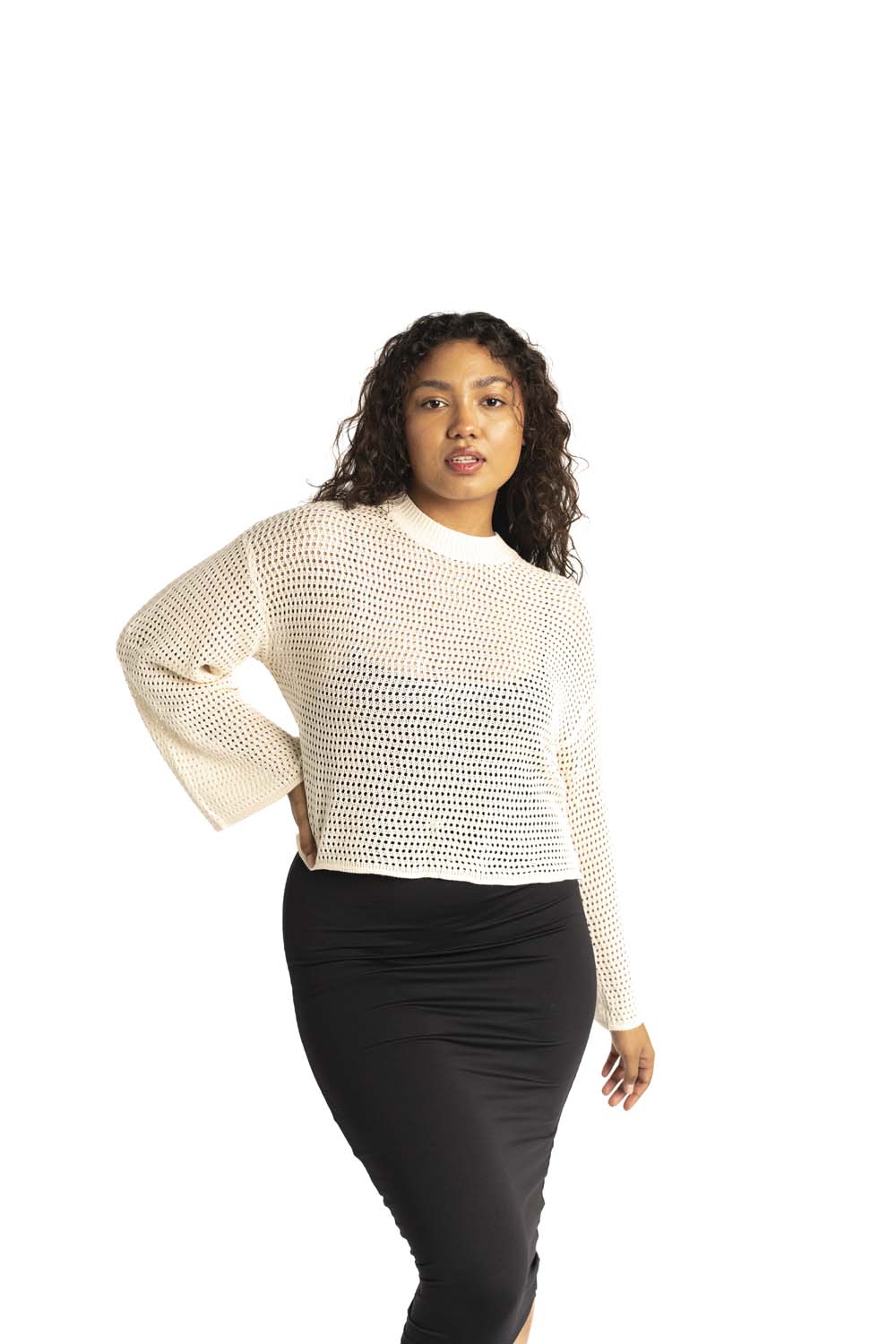 white crochet style open knit sweater worn by woman gyal bashy