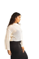 white crochet style open knit sweater worn by woman gyal bashy
