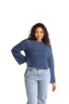 blue crochet style open knit sweater worn by woman gyal bashy